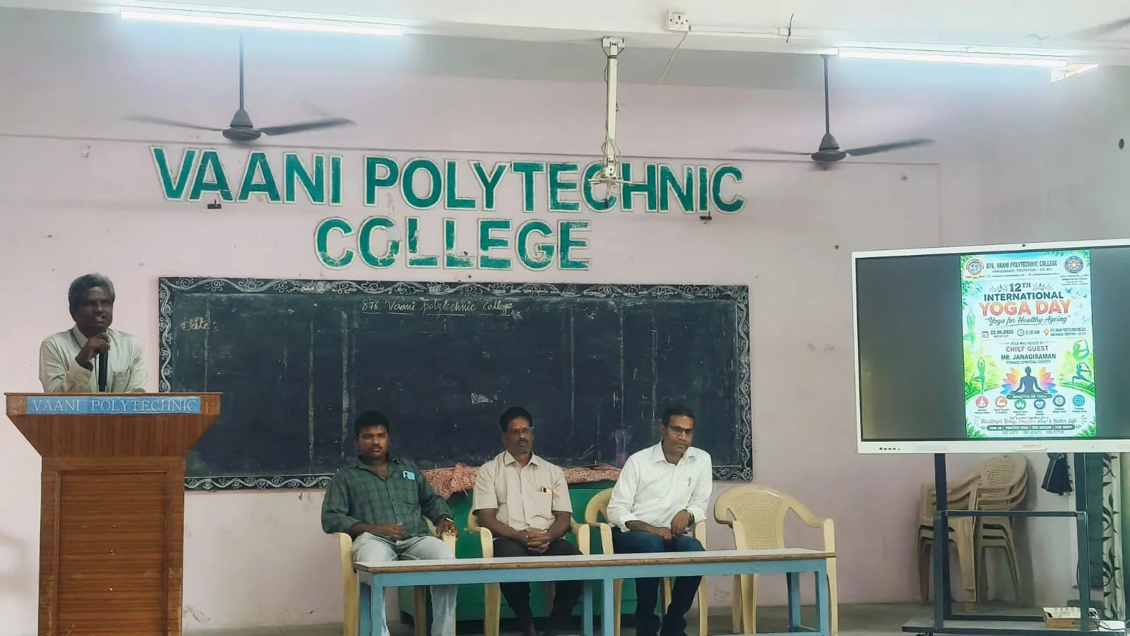 Speaker at the podium during the yoga day session at Vaani Polytechnic College