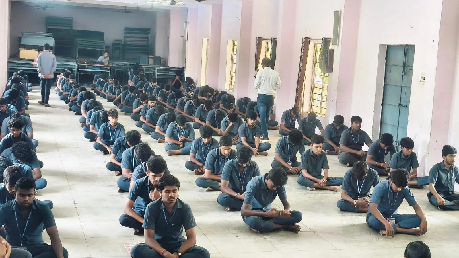 Students of Vaani Polytechnic College meditating with eyes closed during the session