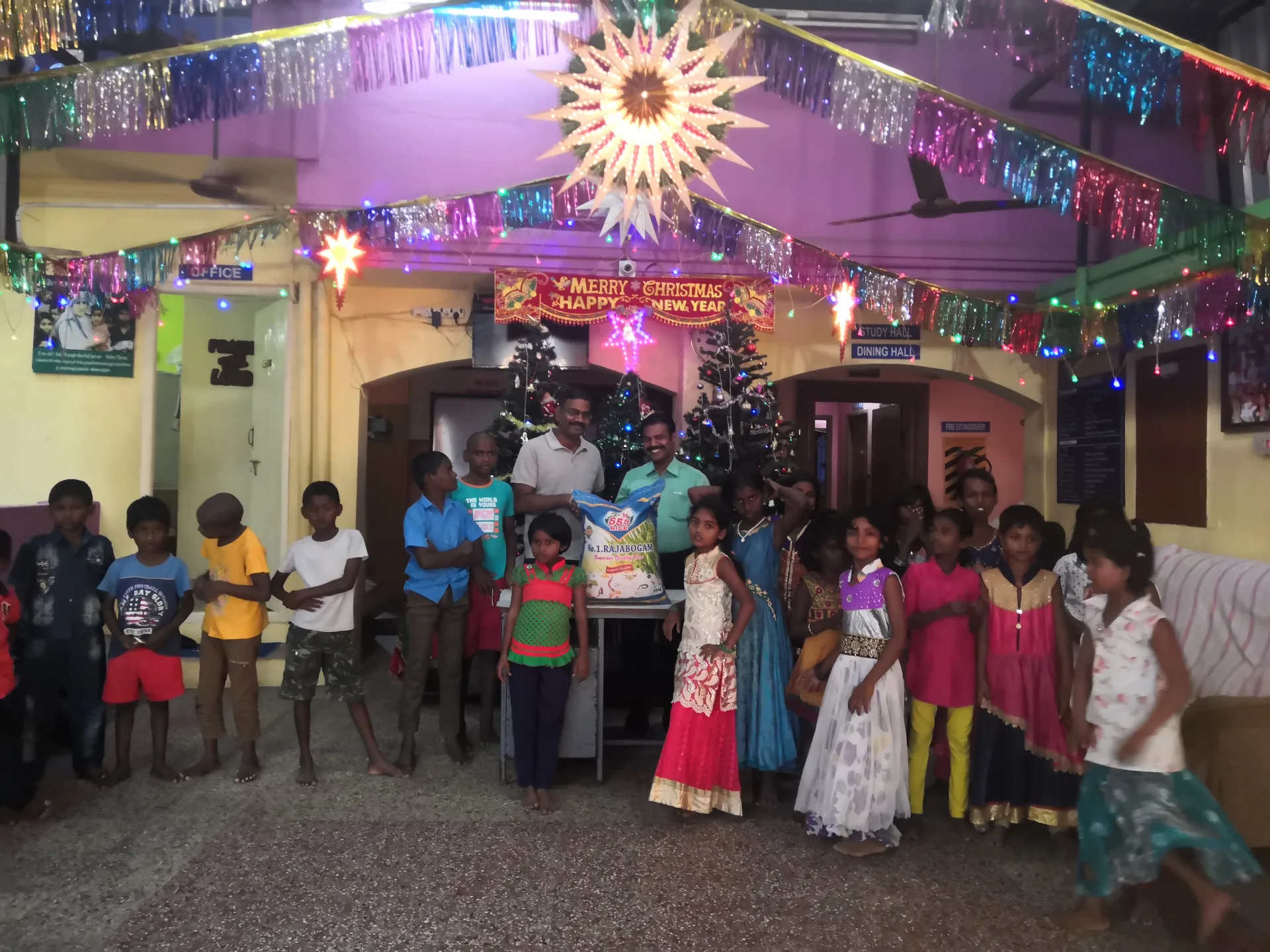 Group photo with the children of New Hope & New Life Children's Home during the rice handover